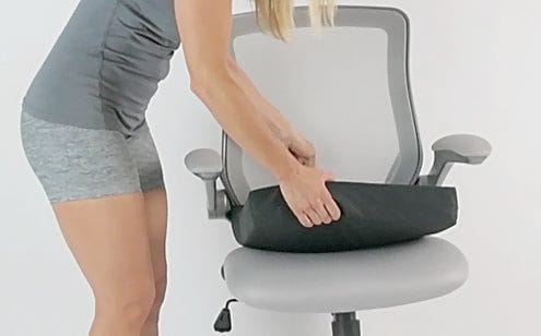 Woman placing wheelchair cushion in the chair