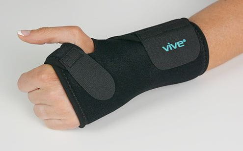 Left hand wearing wrist brace